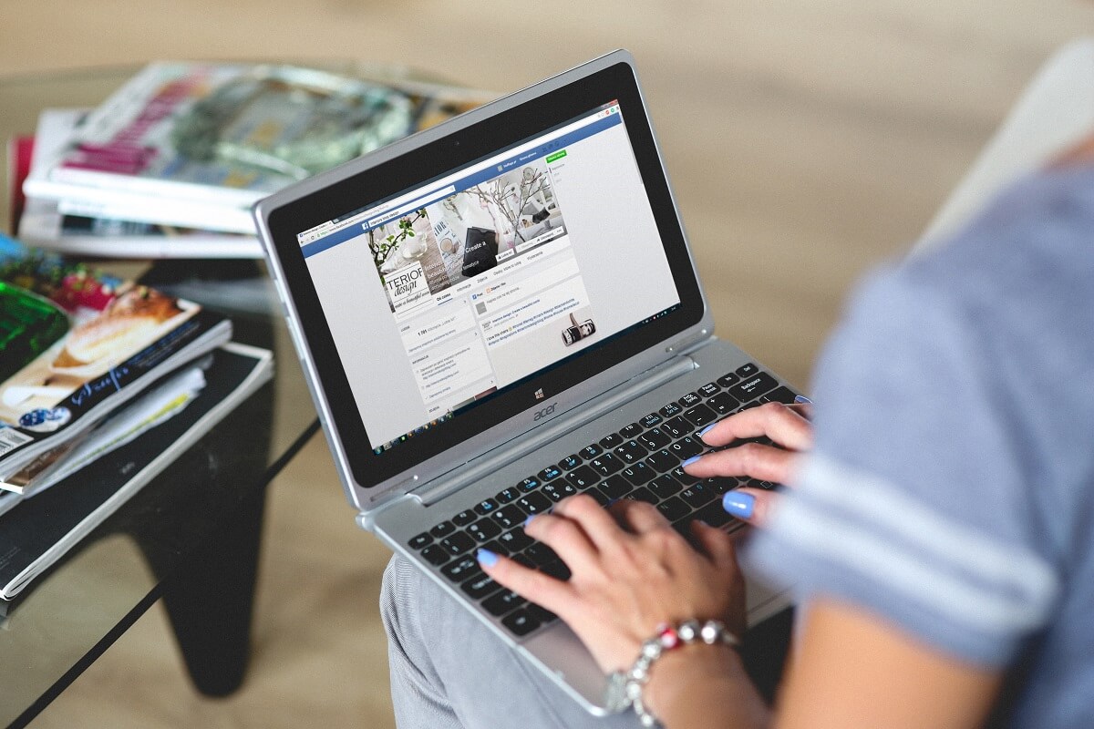 Woman using Facebook on laptop.