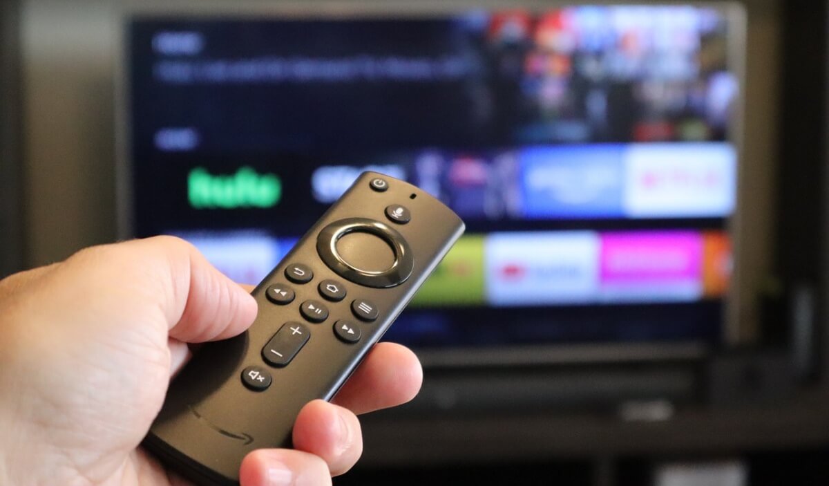 Hand holding Amazon Fire TV remote.