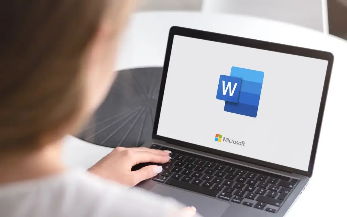 A computer screen displays a Microsoft Word document; the cursor is positioned at the beginning of a blank page, ready for text input